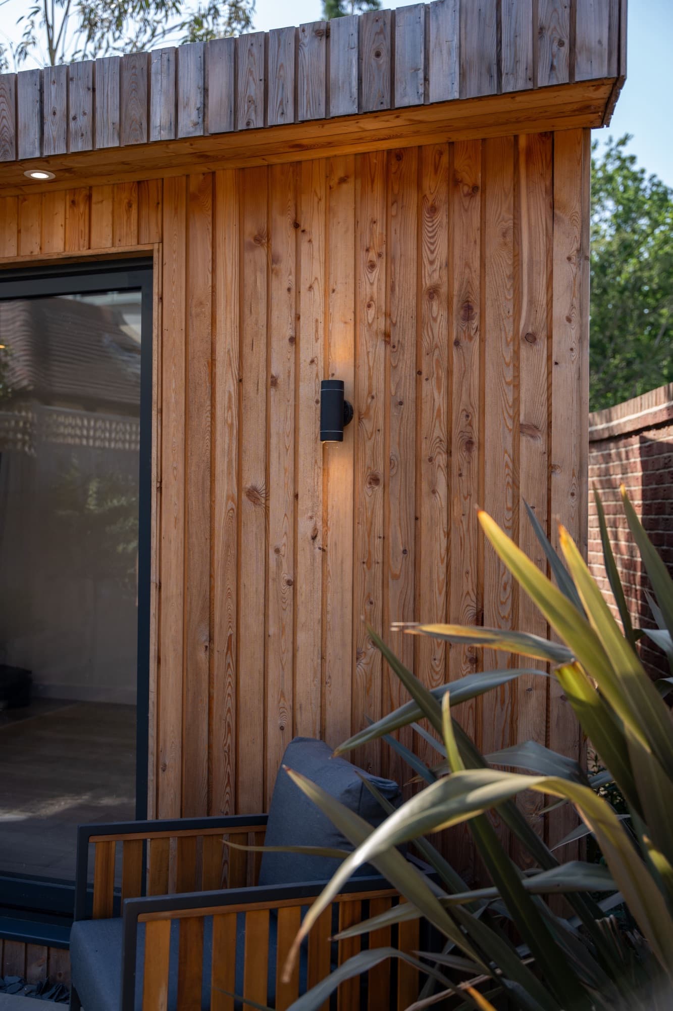 Vertical timber cladding detail with an outdoor wall light