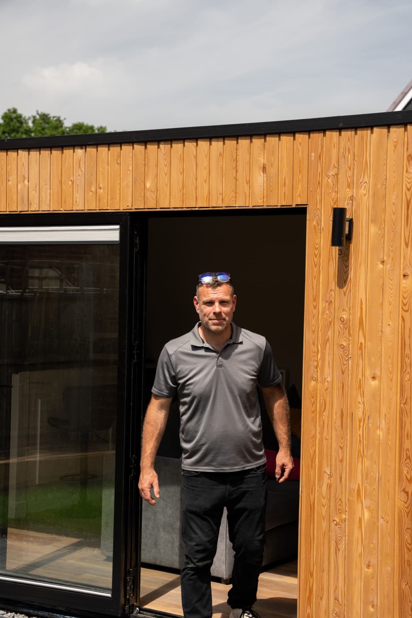 Richard standing in the doorway of a newly finished garden room